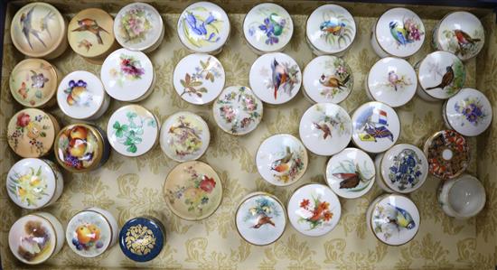 A collection of Royal Worcester and other rouge pots and covers, three fruit painted
